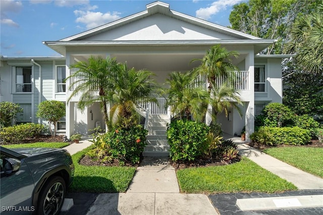 1160 Sarah Jean Cir Unit D204, Naples, FL 34110 - view of front of home featuring stucco siding, stairway, and a porch
