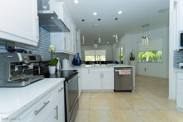 2140 8th St NE, Naples, FL 34120 - kitchen featuring dishwasher, wall chimney range hood, a sink, a peninsula, and backsplash