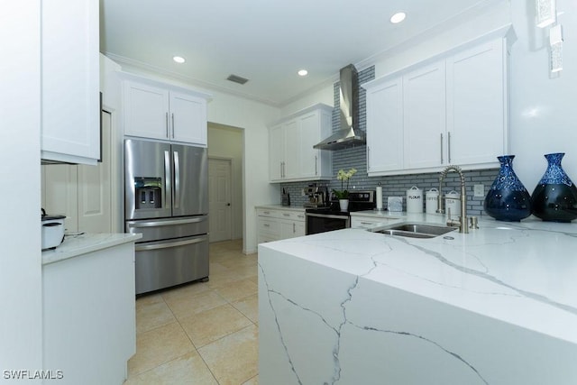 2140 8th St NE, Naples, FL 34120 - kitchen featuring appliances with stainless steel finishes, wall chimney exhaust hood, backsplash, white cabinets, and a sink