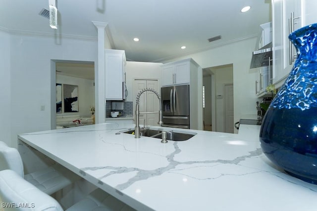 2140 8th St NE, Naples, FL 34120 - kitchen featuring stainless steel refrigerator with ice dispenser, a sink, light stone countertops, white cabinetry, and a peninsula