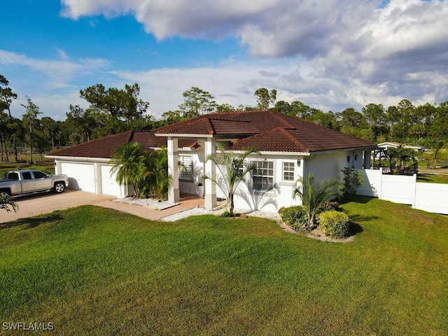 2140 8th St NE, Naples, FL 34120 - mediterranean / spanish home featuring a tile roof, stucco siding, and driveway