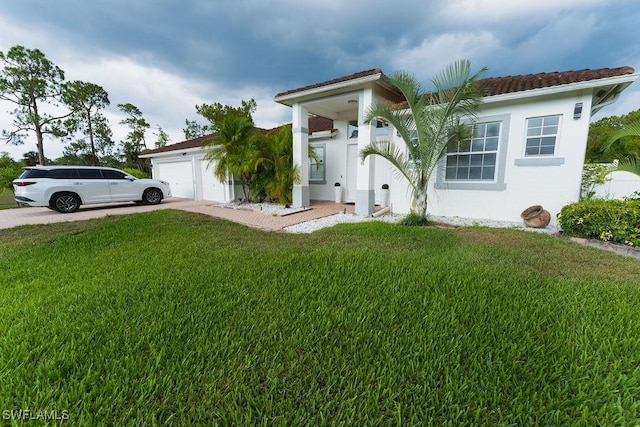 2140 8th St NE, Naples, FL 34120 - view of front facade with a front lawn, a garage, concrete driveway, and stucco siding