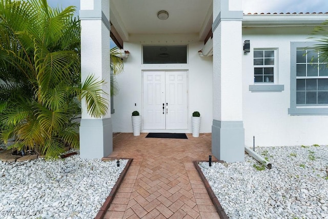 2140 8th St NE, Naples, FL 34120 - doorway to property with stucco siding