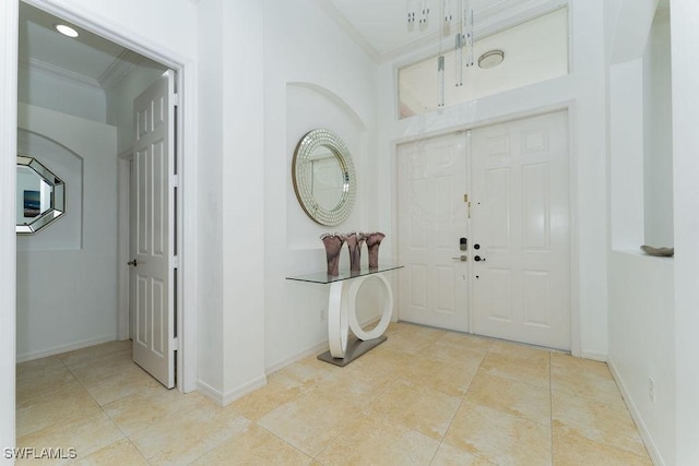 2140 8th St NE, Naples, FL 34120 - foyer entrance with crown molding, baseboards, and light tile patterned flooring