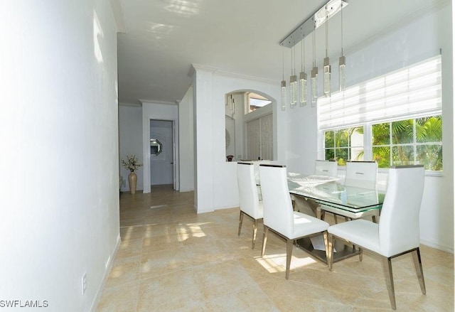 2140 8th St NE, Naples, FL 34120 - dining area with crown molding, arched walkways, and baseboards