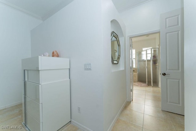 2140 8th St NE, Naples, FL 34120 - corridor featuring ornamental molding, baseboards, arched walkways, and light tile patterned floors