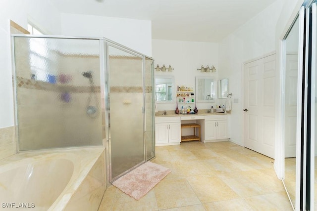 2140 8th St NE, Naples, FL 34120 - bathroom with double vanity, a stall shower, a garden tub, and tile patterned flooring