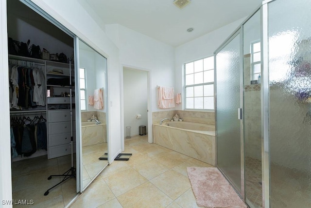 2140 8th St NE, Naples, FL 34120 - bathroom with a garden tub, a spacious closet, a stall shower, and tile patterned flooring