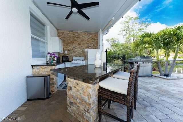 2140 8th St NE, Naples, FL 34120 - view of patio / terrace featuring an outdoor kitchen and ceiling fan