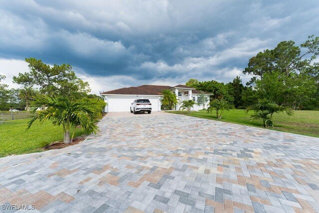 2140 8th St NE, Naples, FL 34120 - view of front facade featuring a front yard, decorative driveway, and a garage