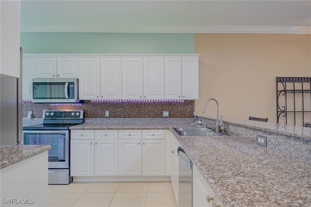 8320 Whiskey Preserve Cir Unit 321, Fort Myers, FL 33919 - kitchen featuring stainless steel appliances, crown molding, white cabinetry, backsplash, and light tile patterned floors