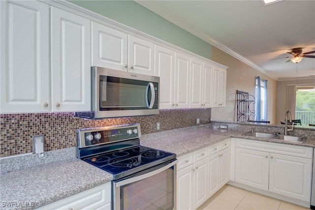 8320 Whiskey Preserve Cir Unit 321, Fort Myers, FL 33919 - kitchen with appliances with stainless steel finishes, a sink, ornamental molding, white cabinets, and tasteful backsplash