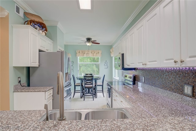 8320 Whiskey Preserve Cir Unit 321, Fort Myers, FL 33919 - kitchen featuring appliances with stainless steel finishes, white cabinetry, crown molding, a sink, and decorative backsplash