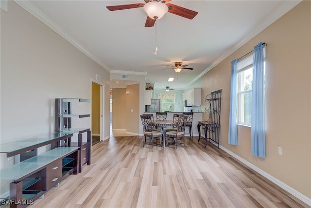 8320 Whiskey Preserve Cir Unit 321, Fort Myers, FL 33919 - dining room featuring a ceiling fan, light wood finished floors, crown molding, and baseboards