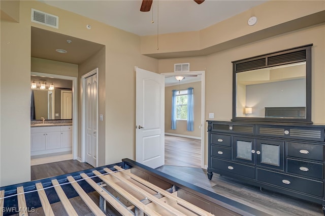 8320 Whiskey Preserve Cir Unit 321, Fort Myers, FL 33919 - unfurnished bedroom with wood finished floors, ensuite bathroom, baseboards, and a sink