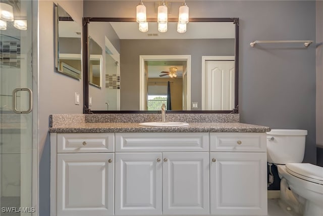 8320 Whiskey Preserve Cir Unit 321, Fort Myers, FL 33919 - bathroom featuring toilet, vanity, a shower stall, and a ceiling fan