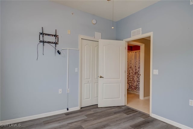 8320 Whiskey Preserve Cir Unit 321, Fort Myers, FL 33919 - unfurnished bedroom with wood finished floors, baseboards, and a closet