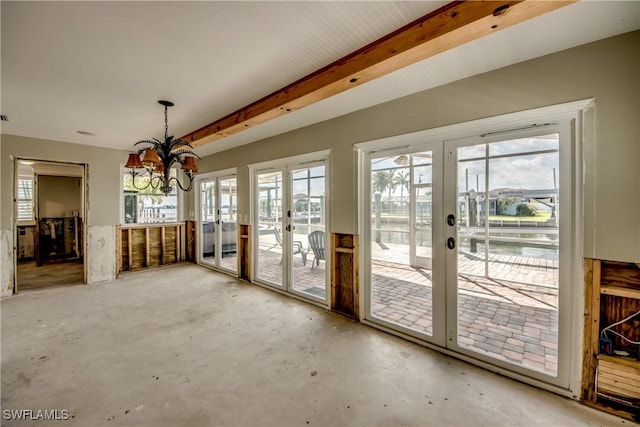 2685 Geary St, Matlacha, FL 33993 - unfurnished dining area featuring french doors, a chandelier, and unfinished concrete flooring