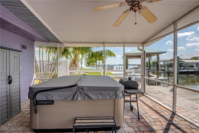 2685 Geary St, Matlacha, FL 33993 - sunroom featuring a hot tub, a water view, and a ceiling fan