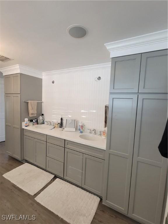 2685 Geary St, Matlacha, FL 33993 - bathroom featuring ornamental molding, wood finished floors, and double vanity
