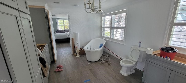 2685 Geary St, Matlacha, FL 33993 - full bath featuring a chandelier, wood finished floors, crown molding, toilet, and a freestanding bath