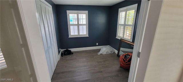 2685 Geary St, Matlacha, FL 33993 - unfurnished bedroom with multiple windows, wood finished floors, and baseboards