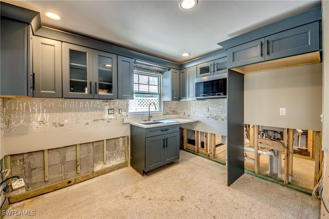 2685 Geary St, Matlacha, FL 33993 - kitchen with stainless steel microwave, backsplash, a sink, recessed lighting, and glass insert cabinets