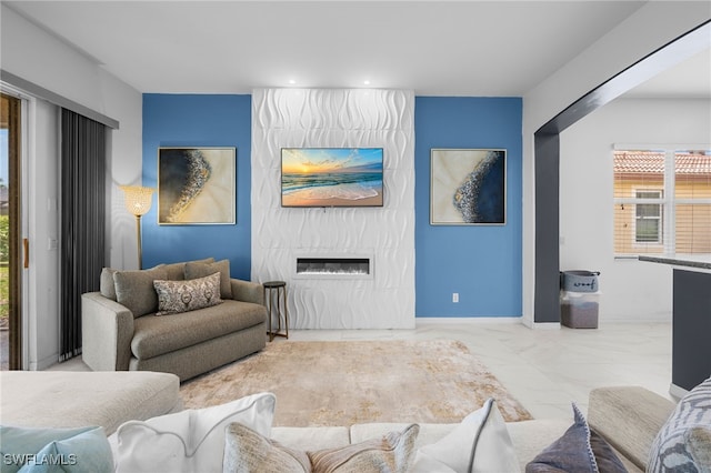 7384 Sika Deer Way, Fort Myers, FL 33966 - living area with marble look tiles, a large fireplace, plenty of natural light, recessed lighting, and baseboards