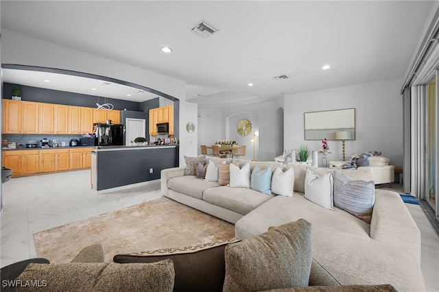7384 Sika Deer Way, Fort Myers, FL 33966 - living room featuring arched walkways, recessed lighting, and light marble finish flooring