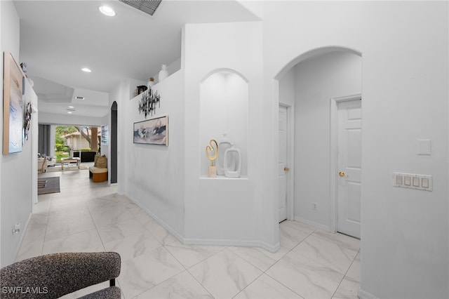 7384 Sika Deer Way, Fort Myers, FL 33966 - hall featuring arched walkways, light marble finish floors, baseboards, and recessed lighting