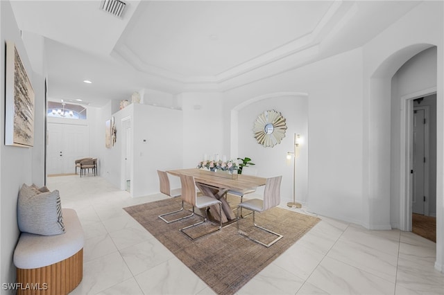 7384 Sika Deer Way, Fort Myers, FL 33966 - dining room with arched walkways, a raised ceiling, and light marble finish flooring