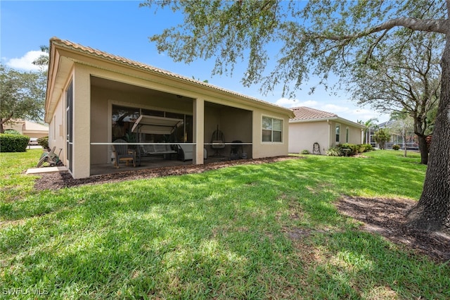 7384 Sika Deer Way, Fort Myers, FL 33966 - back of property with stucco siding, a lawn, and a tiled roof