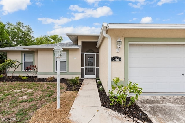 206 SE 12th Ter, Cape Coral, FL 33990 - doorway to property featuring stucco siding and a garage