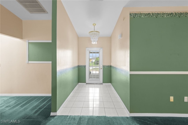 206 SE 12th Ter, Cape Coral, FL 33990 - doorway featuring baseboards, a chandelier, and tile patterned floors