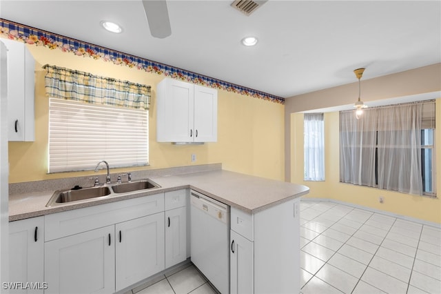 206 SE 12th Ter, Cape Coral, FL 33990 - kitchen featuring white dishwasher, a sink, a peninsula, white cabinets, and light countertops