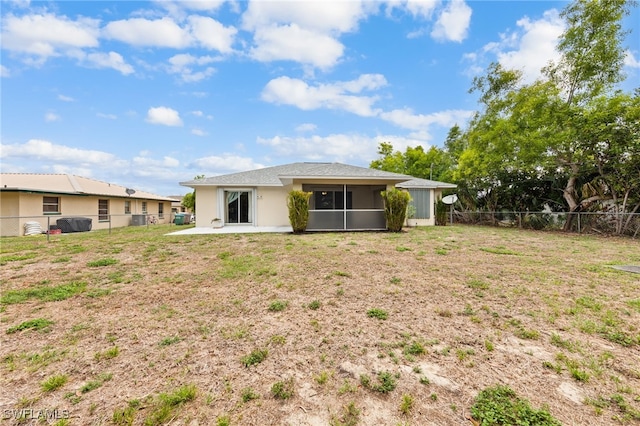 206 SE 12th Ter, Cape Coral, FL 33990 - back of house with a sunroom, stucco siding, and a patio