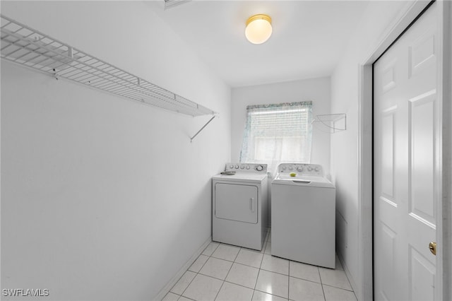 206 SE 12th Ter, Cape Coral, FL 33990 - laundry area featuring washer and clothes dryer, baseboards, and light tile patterned flooring