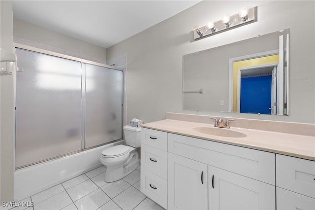 206 SE 12th Ter, Cape Coral, FL 33990 - full bathroom featuring vanity, tile patterned flooring, toilet, and bath / shower combo with glass door