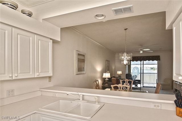 10350 Washingtonia Palm Way Unit 4234, Fort Myers, FL 33966 - kitchen featuring a sink, light countertops, ornamental molding, white cabinetry, and a chandelier