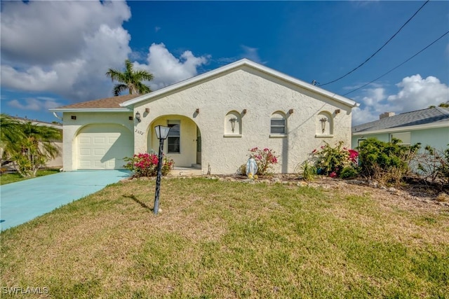 2692 Clyde St, Matlacha, FL 33993 - mediterranean / spanish-style house featuring stucco siding, concrete driveway, a garage, and a front lawn