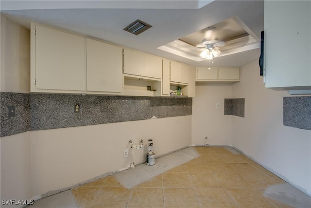 2692 Clyde St, Matlacha, FL 33993 - kitchen with a ceiling fan, light tile patterned flooring, backsplash, and a raised ceiling