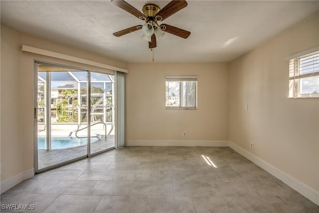 2692 Clyde St, Matlacha, FL 33993 - unfurnished room with ceiling fan, healthy amount of natural light, a sunroom, and baseboards