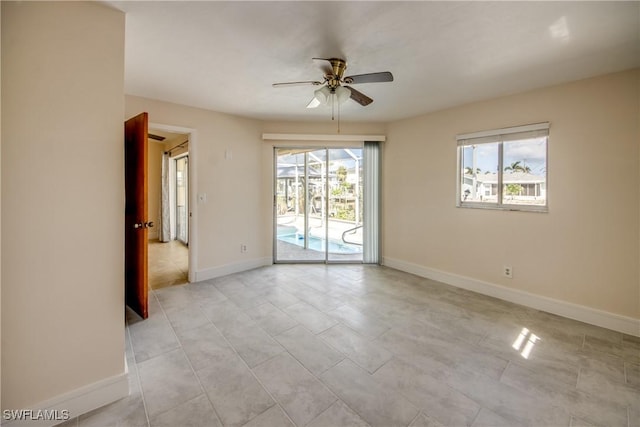 2692 Clyde St, Matlacha, FL 33993 - unfurnished room with a ceiling fan, baseboards, and light tile patterned flooring