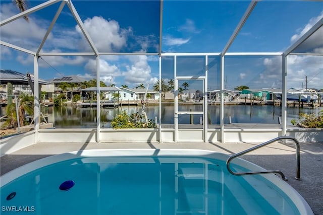 2692 Clyde St, Matlacha, FL 33993 - outdoor pool featuring glass enclosure, a water view, a residential view, and a patio area