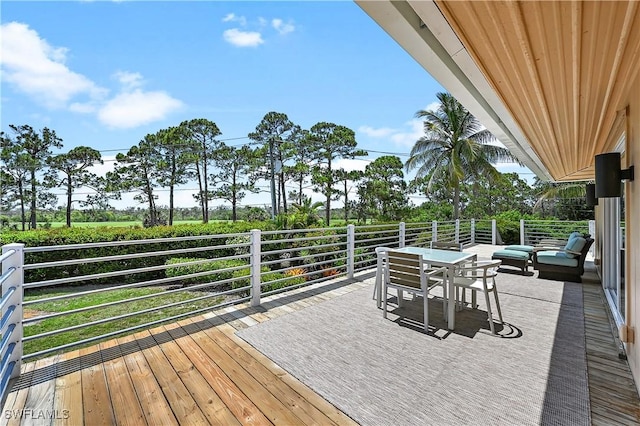 4680 Key Largo Ln, Bonita Springs, FL 34134 - wooden terrace with outdoor dining area