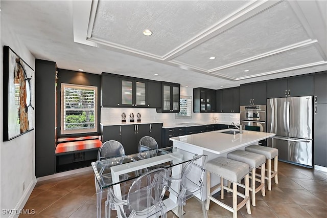 4680 Key Largo Ln, Bonita Springs, FL 34134 - kitchen featuring appliances with stainless steel finishes, light tile patterned flooring, recessed lighting, glass insert cabinets, and decorative backsplash