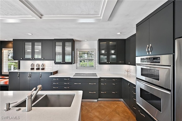 4680 Key Largo Ln, Bonita Springs, FL 34134 - kitchen featuring double oven, a sink, plenty of natural light, tasteful backsplash, and recessed lighting