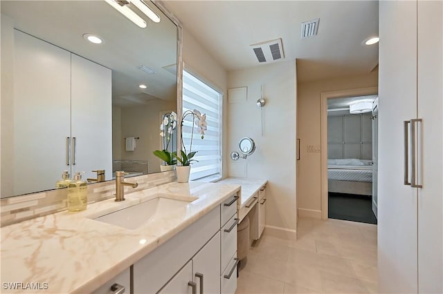 4680 Key Largo Ln, Bonita Springs, FL 34134 - ensuite bathroom featuring vanity, baseboards, tile patterned flooring, and recessed lighting
