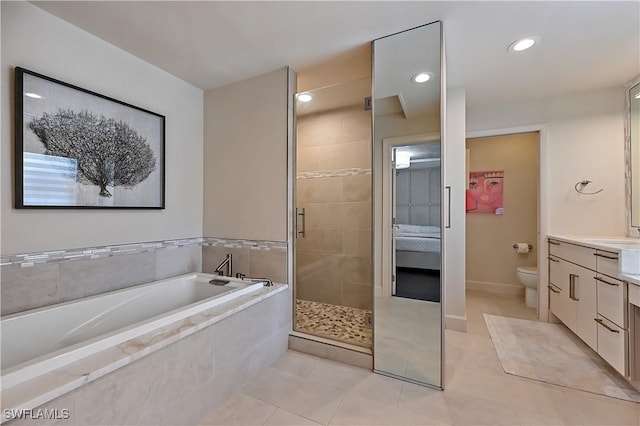 4680 Key Largo Ln, Bonita Springs, FL 34134 - full bath with vanity, a garden tub, a shower stall, tile patterned floors, and toilet