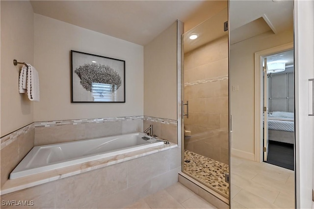 4680 Key Largo Ln, Bonita Springs, FL 34134 - ensuite bathroom featuring a garden tub, a stall shower, and tile patterned flooring